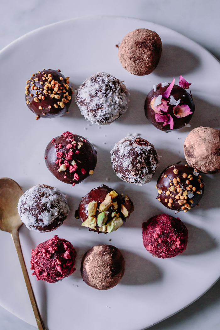Simple + Easy Raw Vegan Adaptogen Coconut Cacao Bliss Balls recipe with Reishi & He Shou Wu. These healthy, protein and superfood packed energy bites are made with dates, almonds, raw chocolate powder, and healing herbs making them the perfect dairy-free, gluten-free, paleo, and Whole 30 friendly snack! Even kids love them!