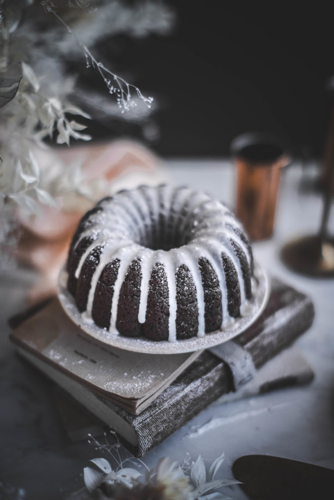 Dark Chocolate Orange Blossom Bundt Cake with Whiskey, Buttermilk Cardamom, and Nutmeg + an Orange Flower & Creme Fraiche Glaze. This recipe for Christmas dessert cakes is rich, moist, fudgy, and easy to bake from scratch with kids! | #foodphotography and #foodstyling by Beth Kirby / Local Milk