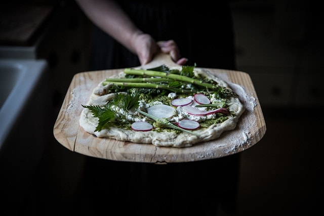 Homemade flatbread with fresh ricotta and asparagus along with a garlic pesto